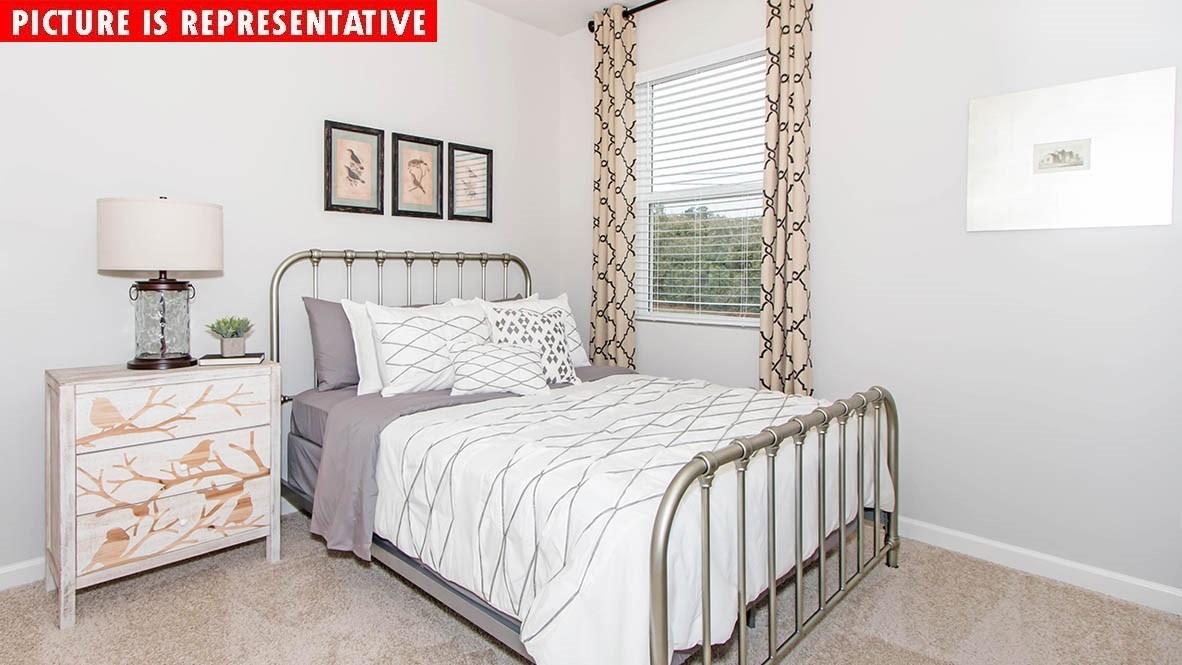 115 Flame Azalea Court Locust, NC 28097 - Photo 14 of 22 a bedroom with a bed and a window