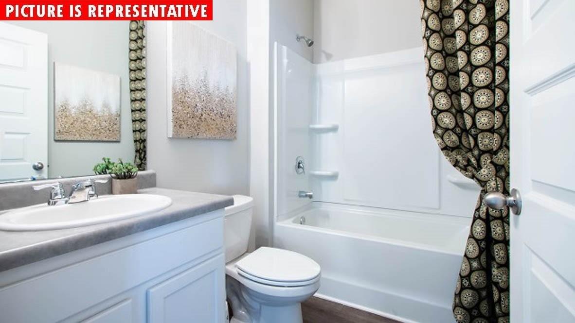 115 Flame Azalea Court Locust, NC 28097 - Photo 17 of 22 a bathroom with a sink toilet and shower