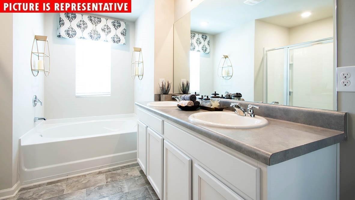 115 Flame Azalea Court Locust, NC 28097 - Photo 22 of 22 a bathroom with a sink and a mirror