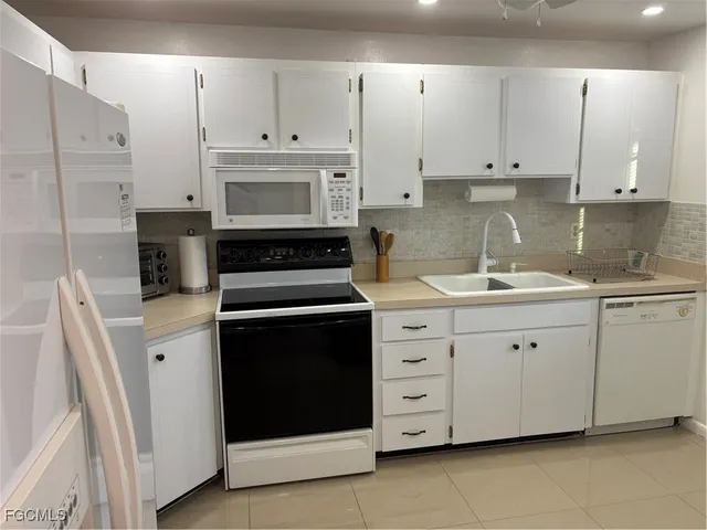a kitchen with cabinets appliances and a sink