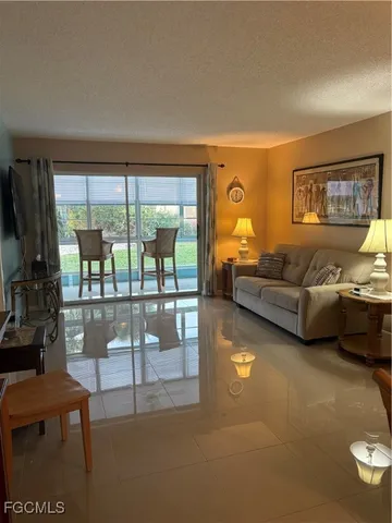 a living room with furniture and a floor to ceiling window