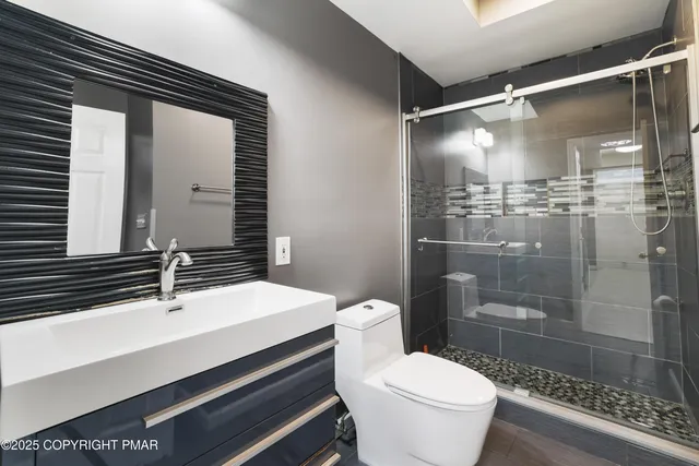 a bathroom with a sink toilet and shower