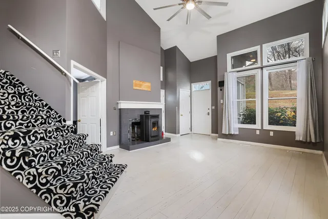 a view of an empty room with a fireplace and a chandelier