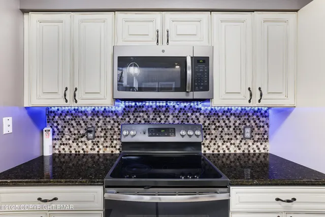 a stove top oven sitting inside of a kitchen
