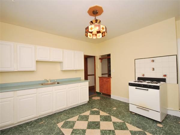 21 Taft Street Boston, MA 02125 - Photo 6 of 9 a kitchen with a sink a stove and cabinets