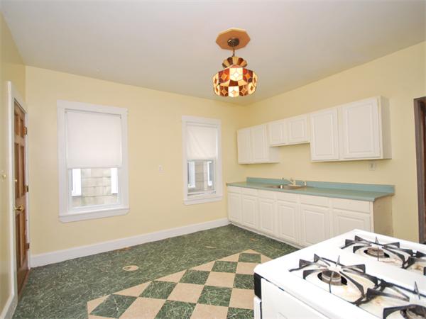 21 Taft Street Boston, MA 02125 - Photo 7 of 9 a kitchen with a stove a sink and cabinets