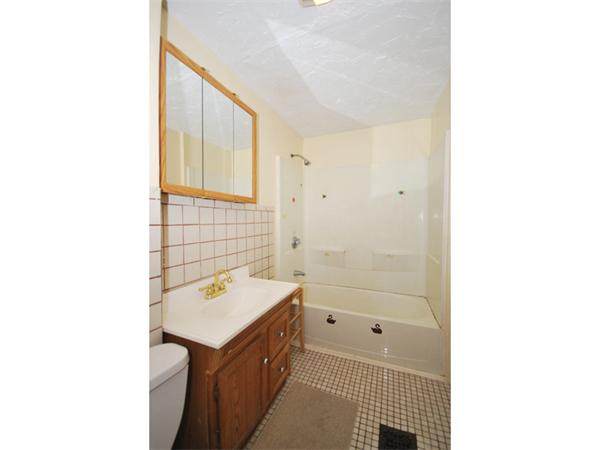 21 Taft Street Boston, MA 02125 - Photo 8 of 9 a bathroom with a sink a toilet and shower