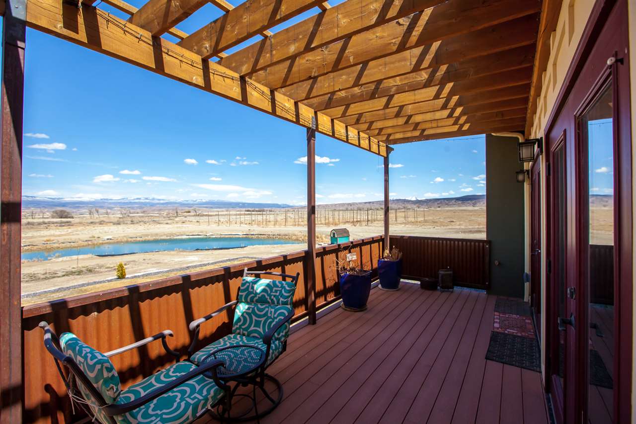 3306 2000th Road Delta, CO 81416 - Photo 5 of 42 a view of a balcony with chairs and wooden floor