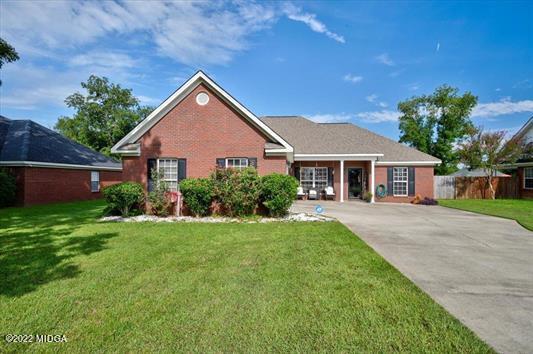 6779 Houston Road Macon, GA 31216 - Photo 2 of 33 a front view of a house with a yard and garage