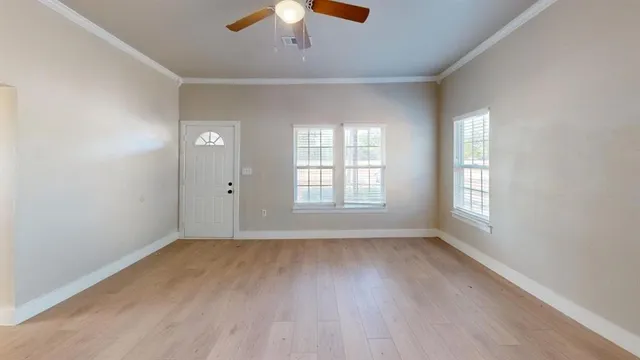 wooden floor in an empty room with a window