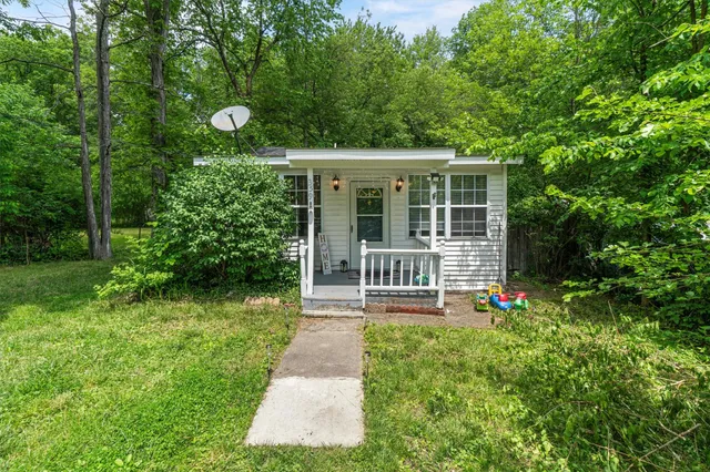 a front view of a house with a yard table and chairs