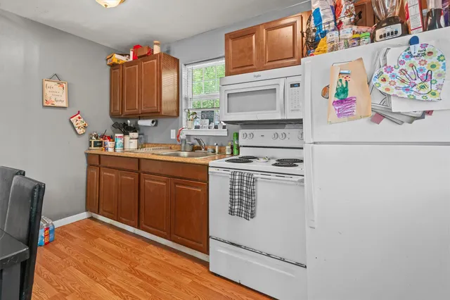 a kitchen with a refrigerator and a sink