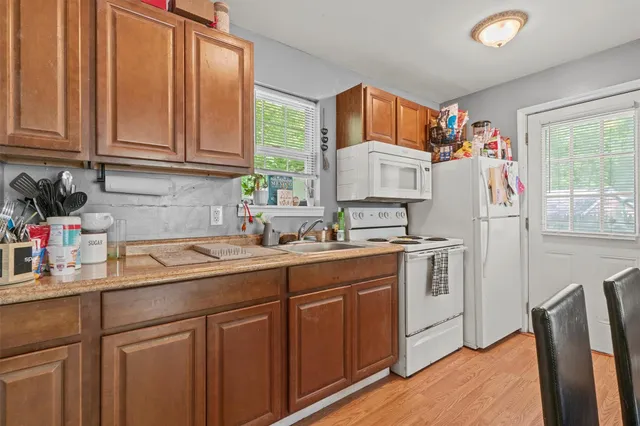 a kitchen with stainless steel appliances granite countertop a refrigerator sink and cabinets