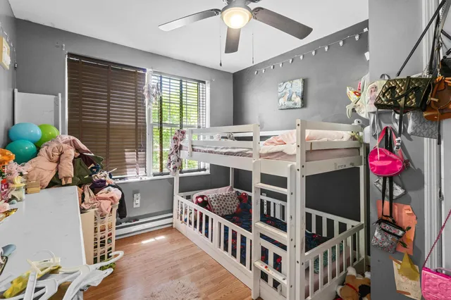 a bedroom with furniture a chandelier and a window