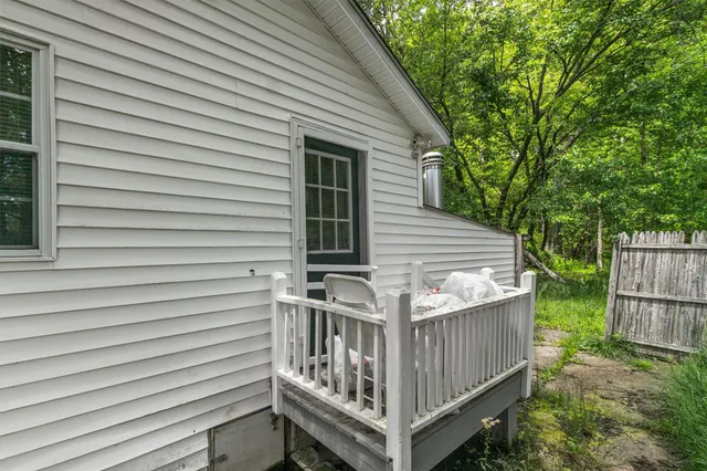 a view of a wooden house with a small yard