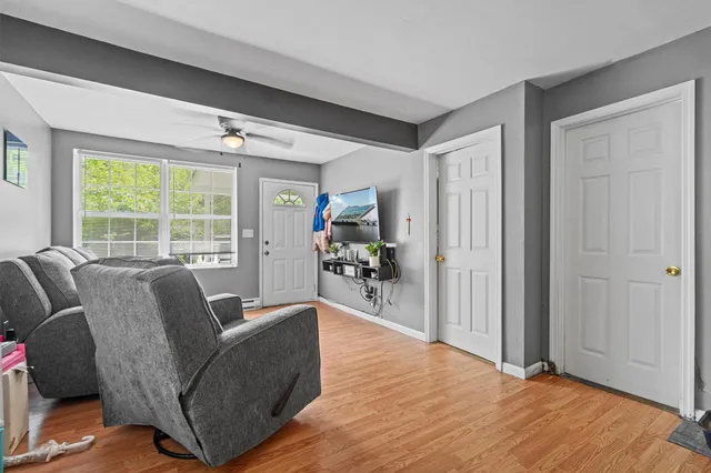 a living room with furniture and a large window