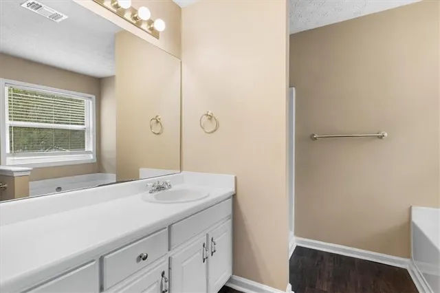 a bathroom with a sink a vanity and a large mirror