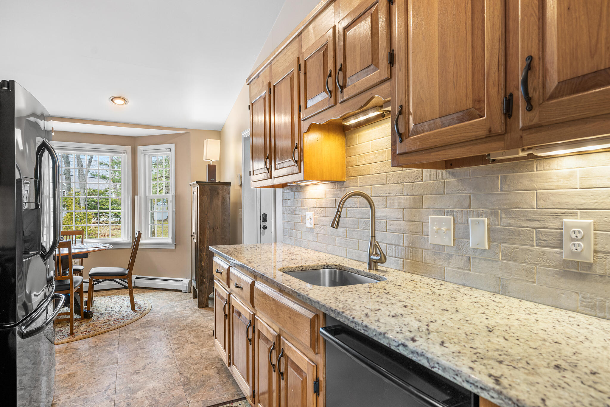 175 Old Post Road Centerville, MA 02632 - Photo 6 of 28 a kitchen with stainless steel appliances granite countertop a sink and cabinets