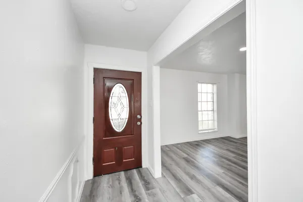 a view of a livingroom with wooden floor and a window