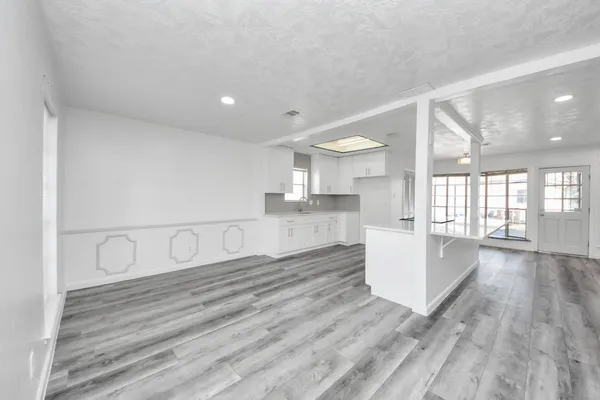 a view of a kitchen and wooden floor
