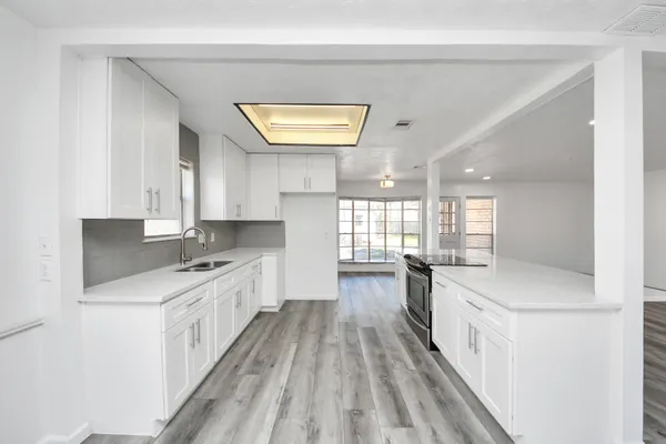 a kitchen with a sink stove and cabinets