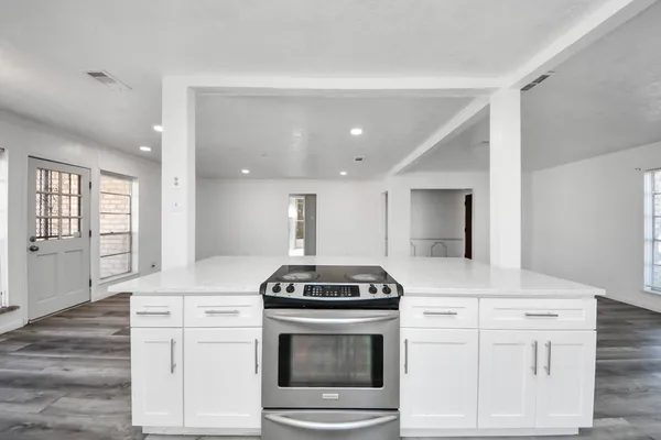 a kitchen with white cabinets and white appliances