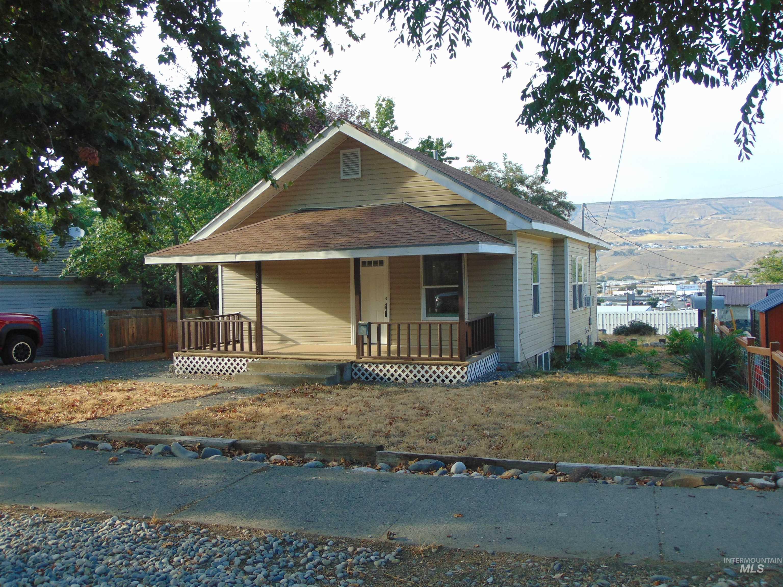 View of front of property featuring a porch and a shingled roof