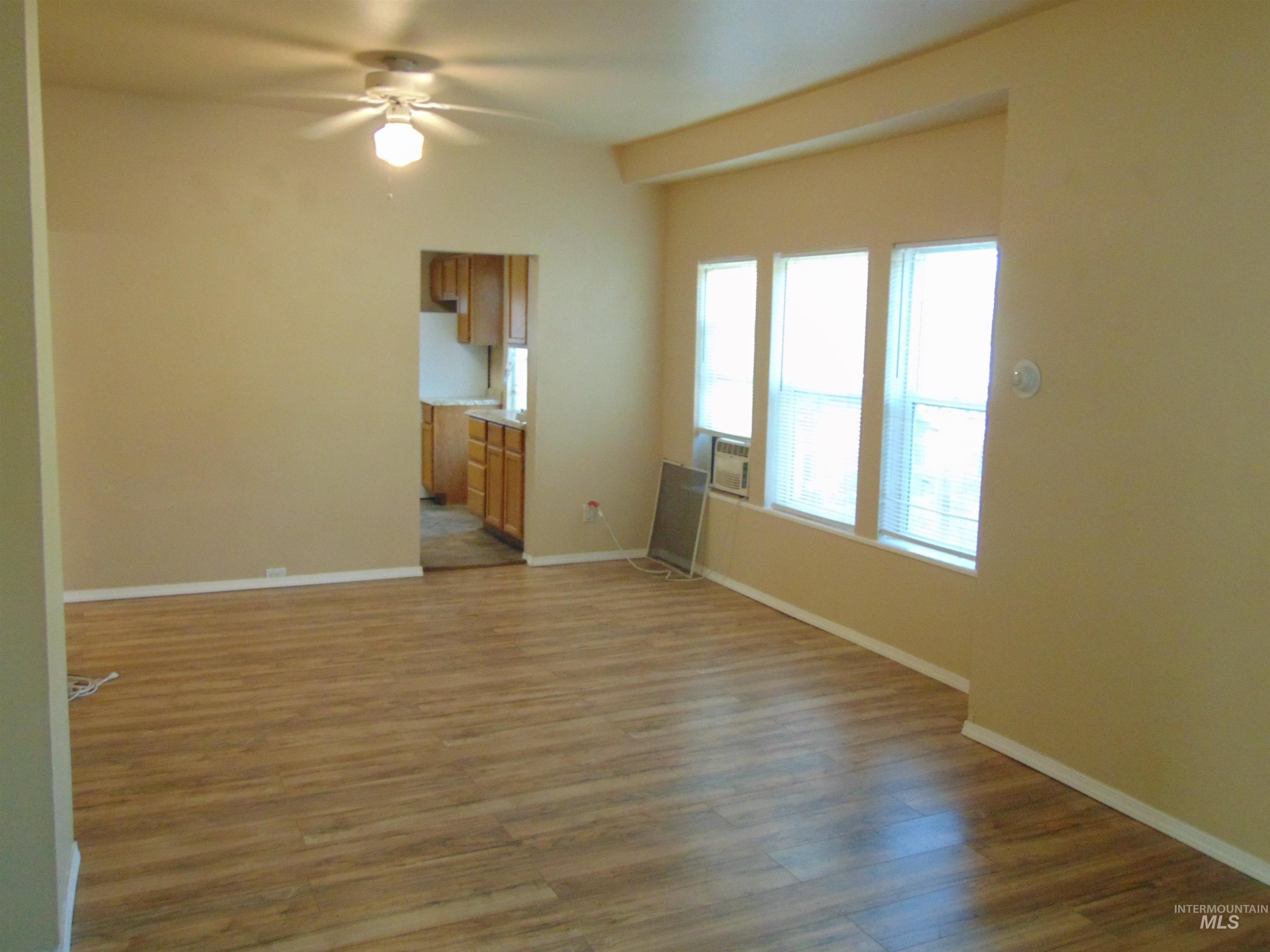 1825 7th Avenue Lewiston, ID 83501 - Photo 5 of 26 Unfurnished living room featuring light wood finished floors and a ceiling fan