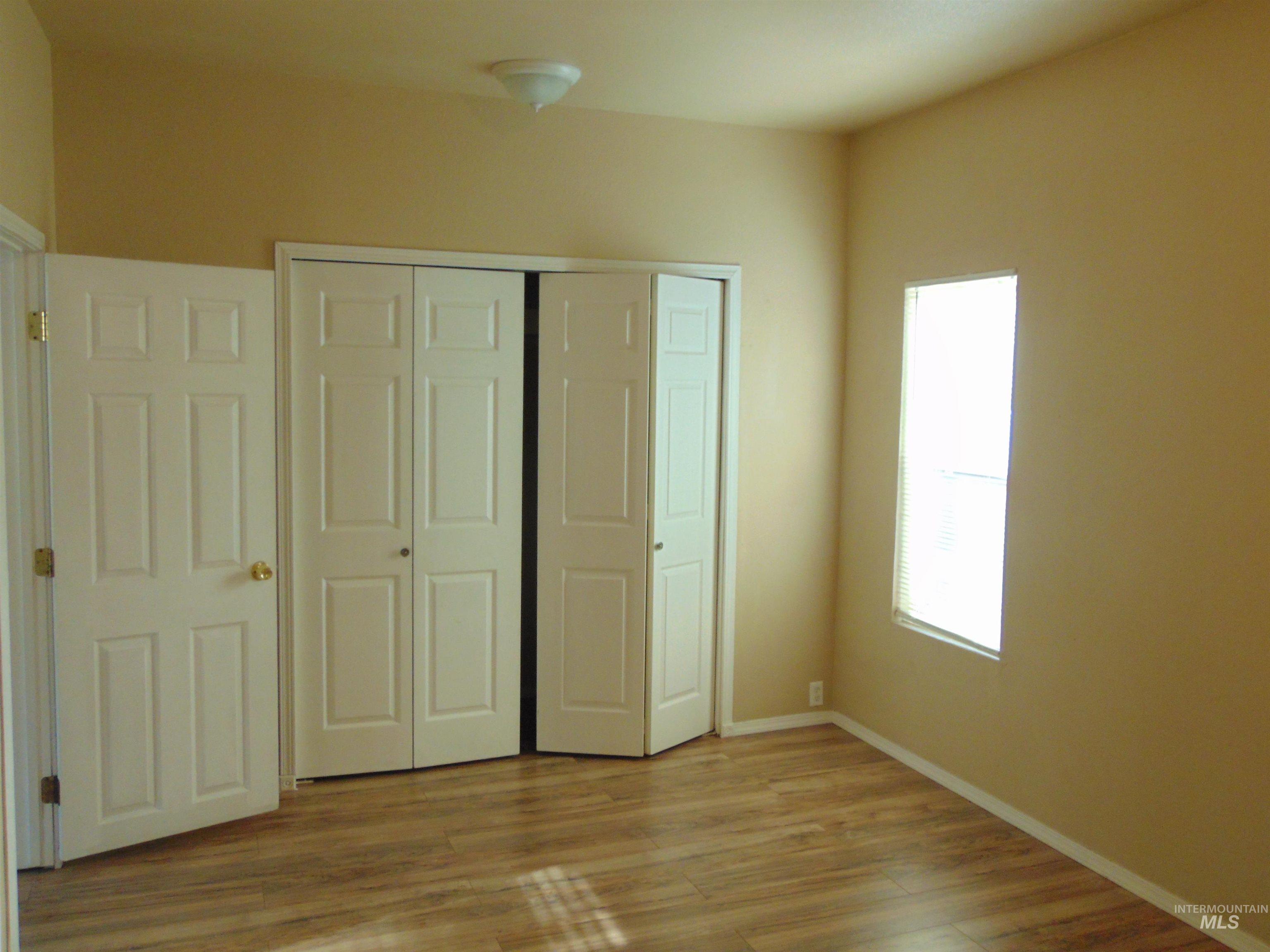 1825 7th Avenue Lewiston, ID 83501 - Photo 7 of 26 Unfurnished bedroom featuring a closet and light wood-style floors