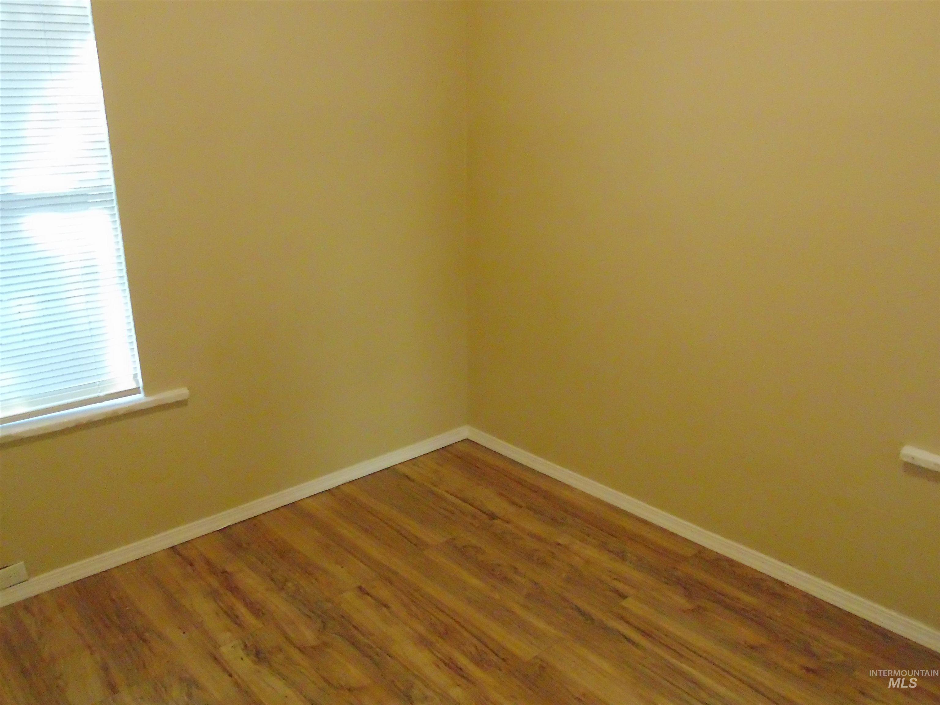 1825 7th Avenue Lewiston, ID 83501 - Photo 10 of 26 Empty room featuring baseboards and wood finished floors