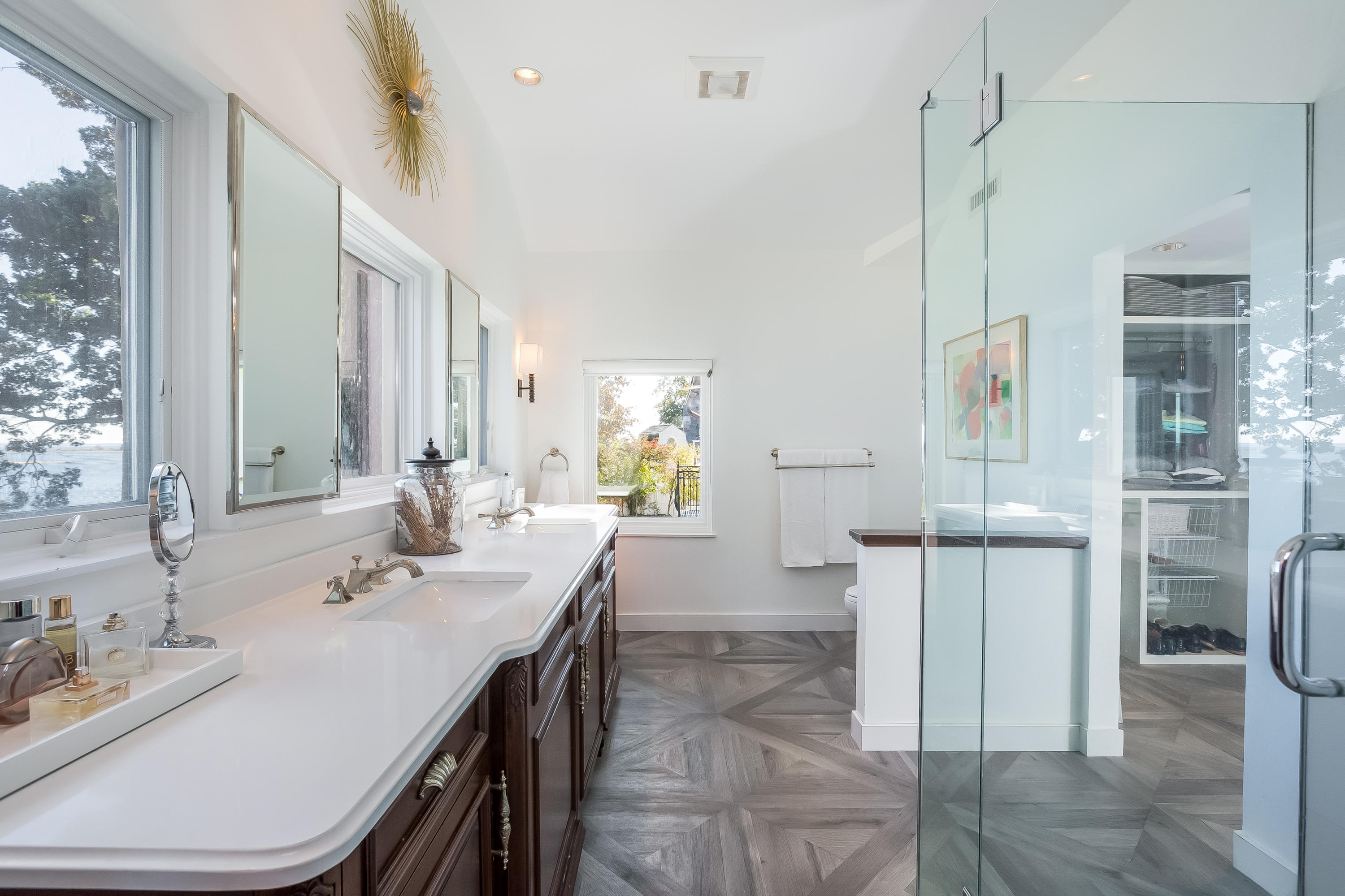 8 Woodland Road Norwalk, CT 06854 - Photo 23 of 44 a spacious bathroom with a double vanity sink a mirror and a shower