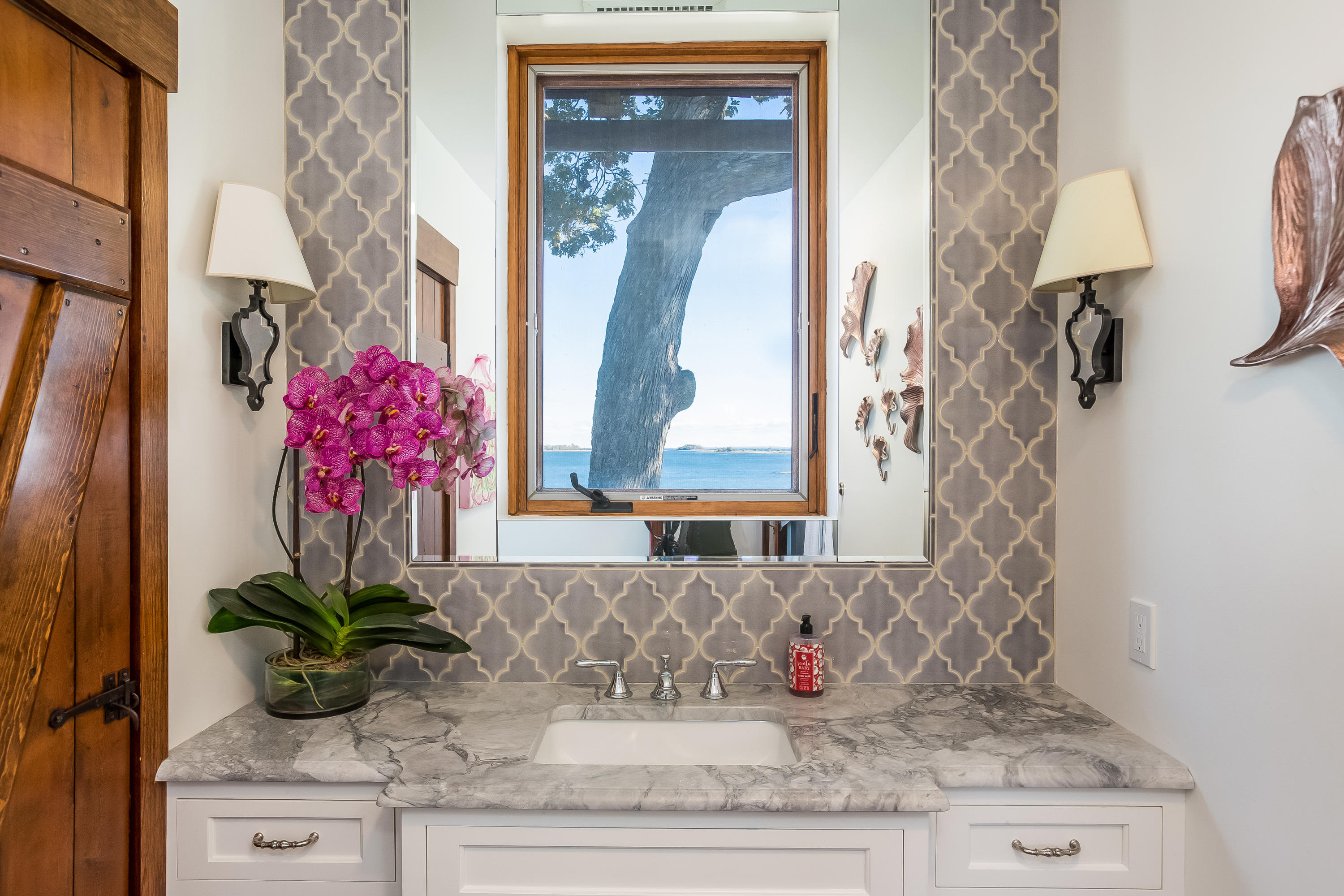 8 Woodland Road Norwalk, CT 06854 - Photo 27 of 44 a bathroom with a granite countertop sink a mirror and a shower curtain