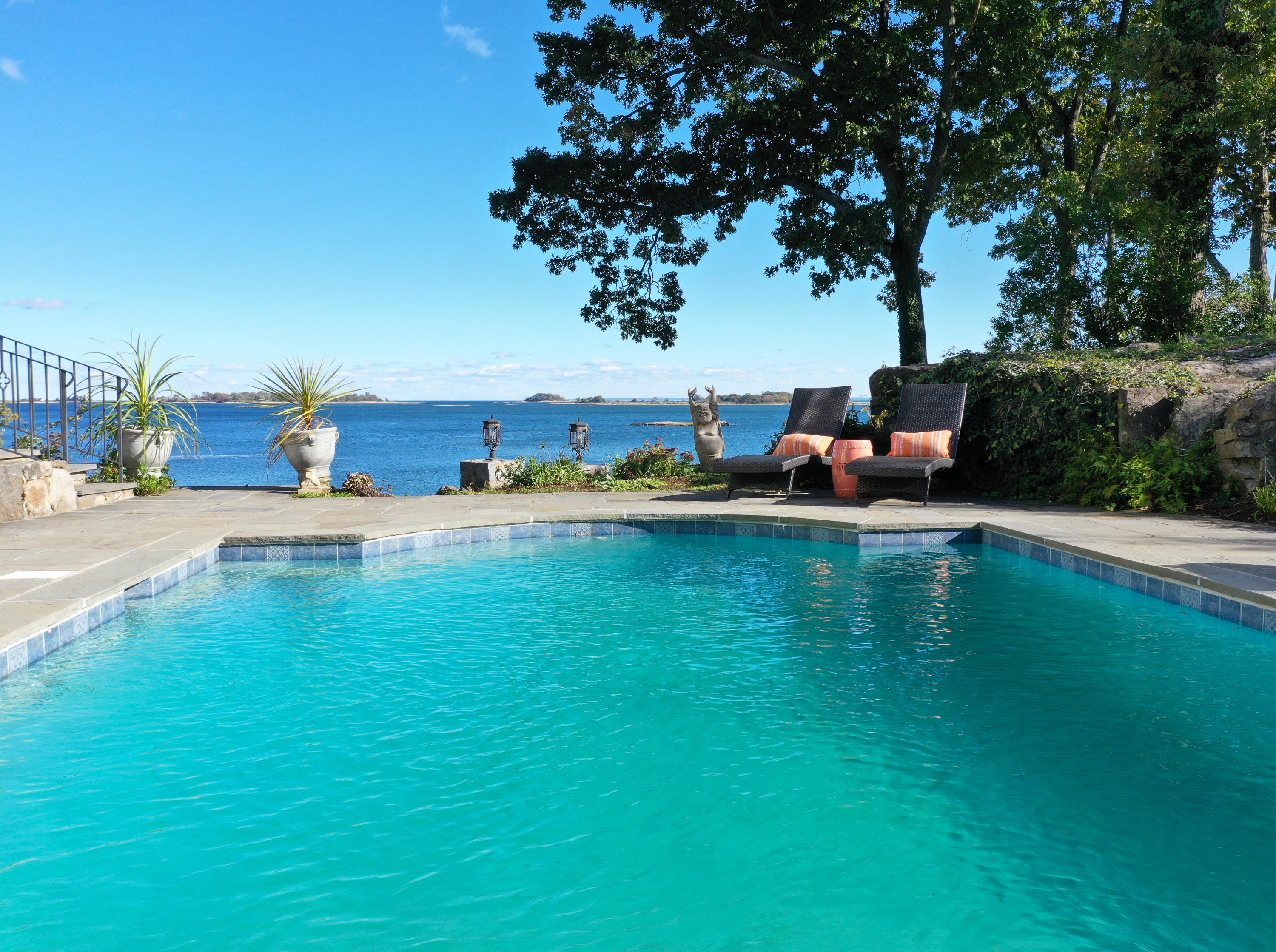 8 Woodland Road Norwalk, CT 06854 - Photo 3 of 44 a view of pool with lawn chairs and a fire pit