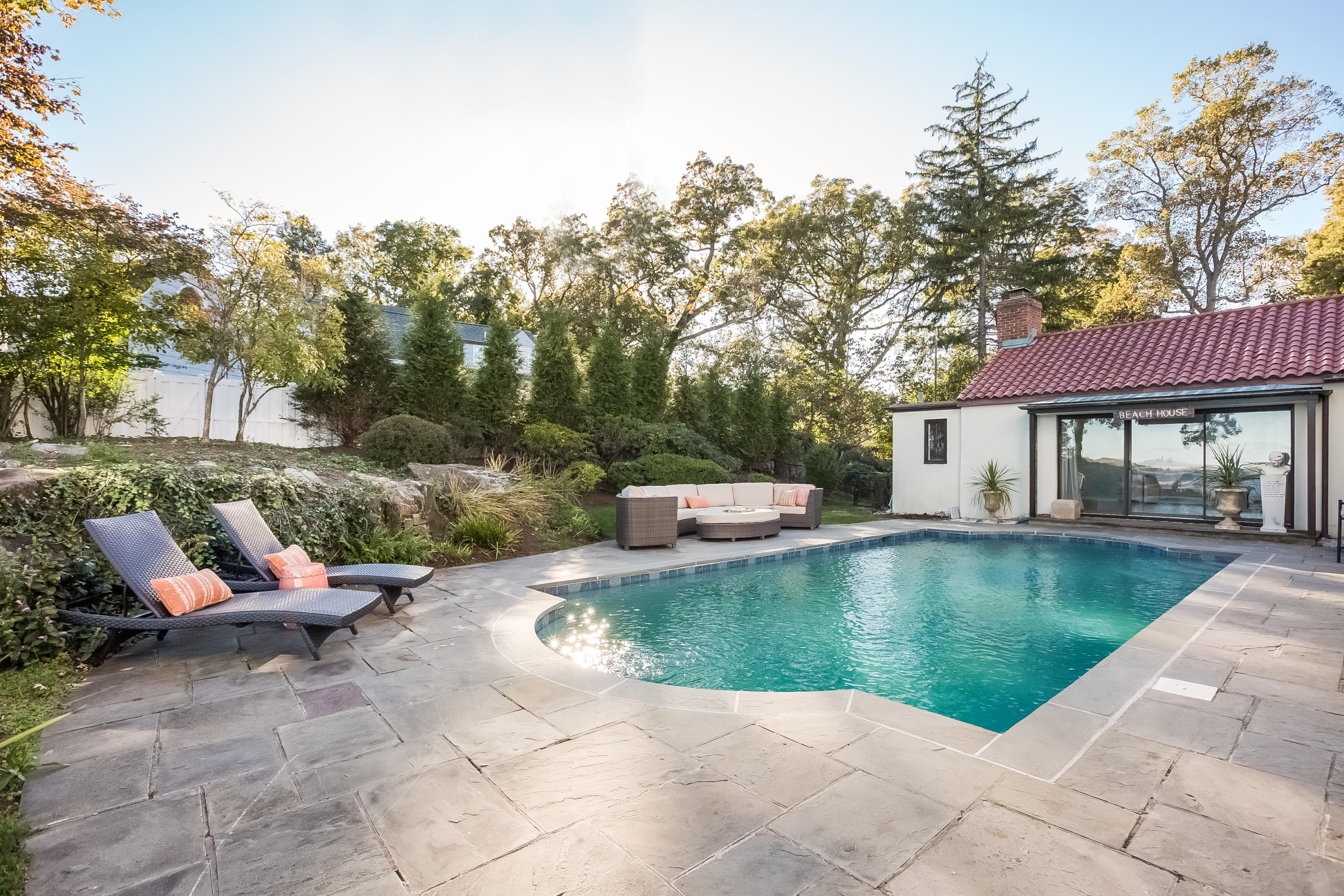 8 Woodland Road Norwalk, CT 06854 - Photo 35 of 44 a view of a swimming pool with a lounge chair