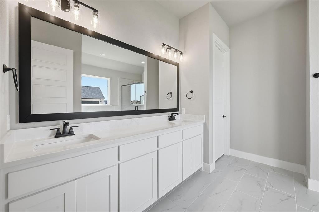 108 Rocky Top Azle, TX 76020 - Photo 16 of 40 a bathroom with double sink and a mirror