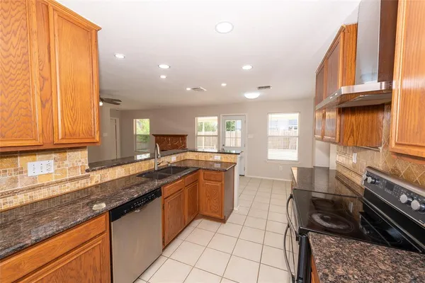a kitchen with a sink stove and cabinets