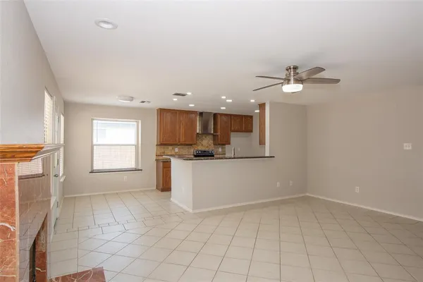 a view of kitchen with granite countertop white cabinets and white appliances