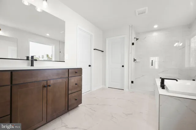 a bathroom with a shower sink and mirror
