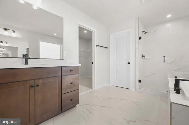 an empty room with white wall and closet