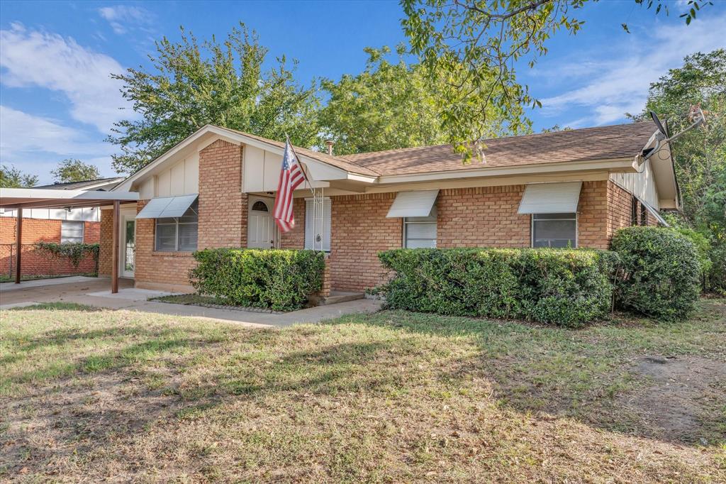 309 South Rita Street Lacy-Lakeview, TX 76705 - Photo 1 of 1 View of front of property featuring a front yard, brick siding, and board and batten siding