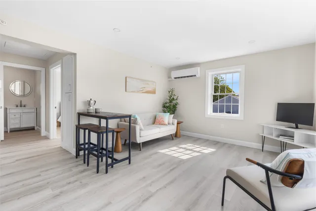 a view of a livingroom with furniture and a flat screen tv