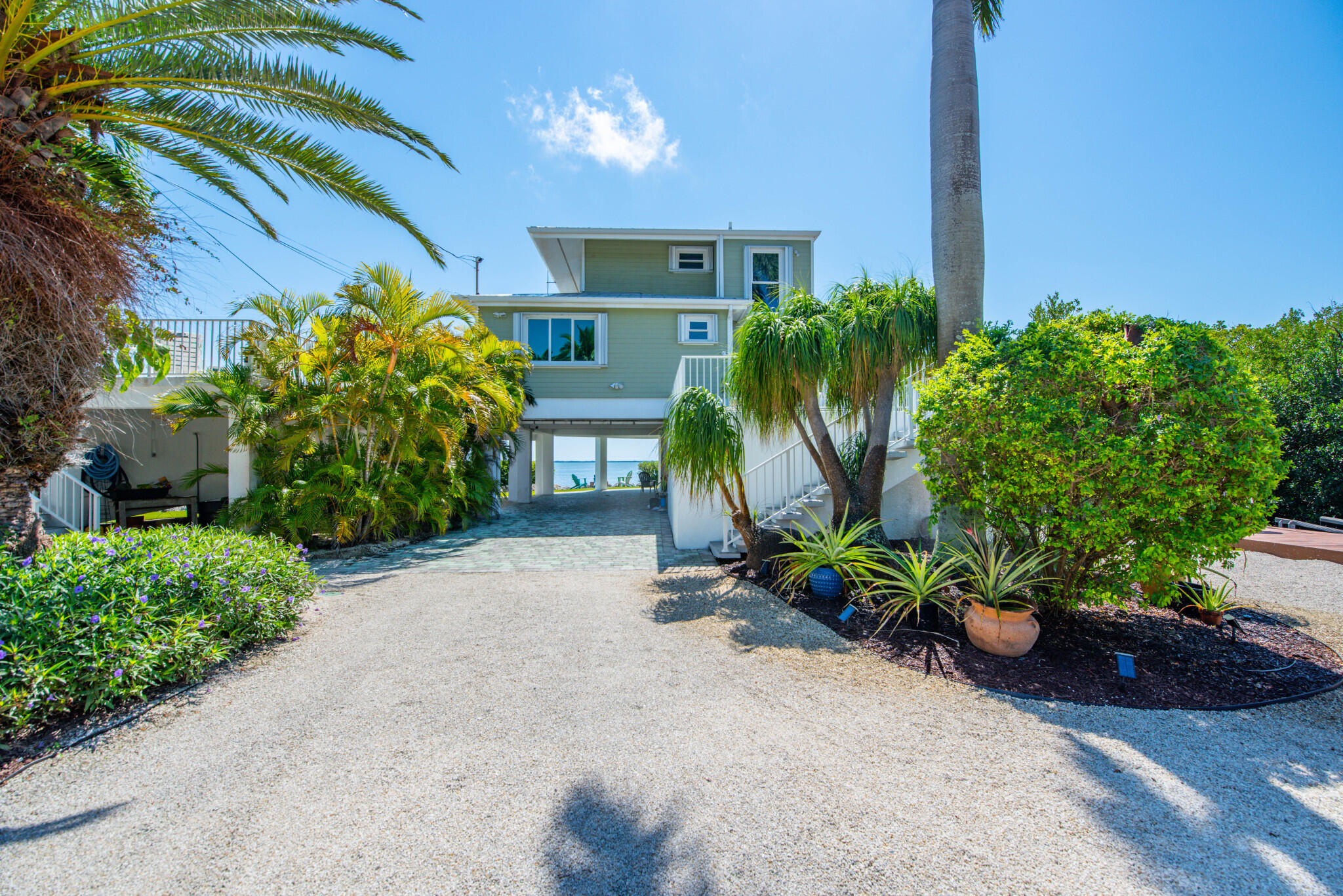 1176 Thatch Lane Cudjoe, FL 33042 - Photo 13 of 41 a potted plant sitting in front of a house