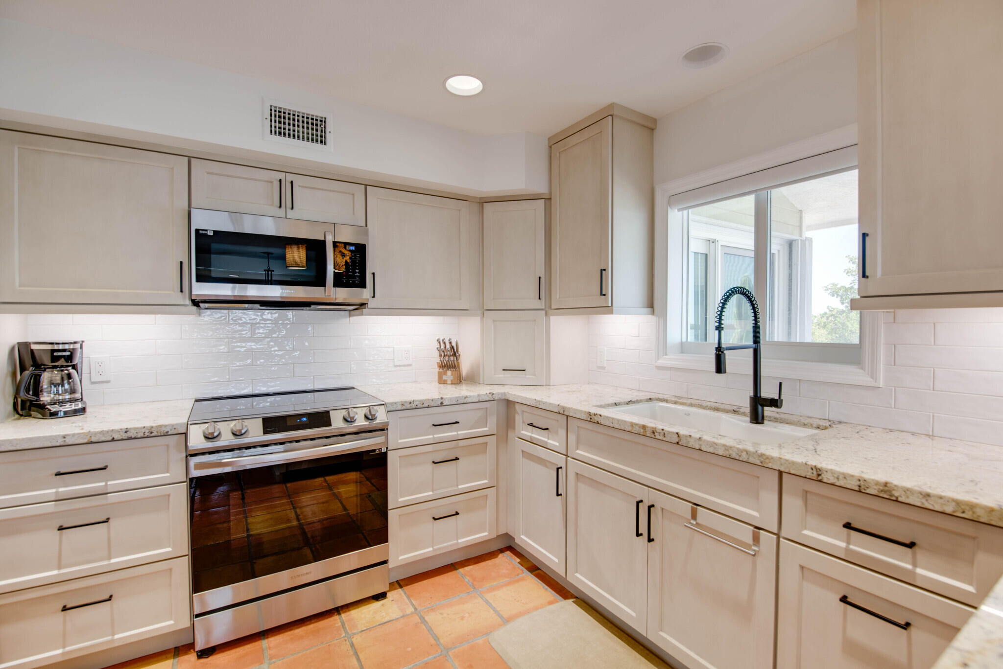 1176 Thatch Lane Cudjoe, FL 33042 - Photo 24 of 41 a kitchen with stainless steel appliances granite countertop a sink dishwasher a stove and a microwave oven with cabinets