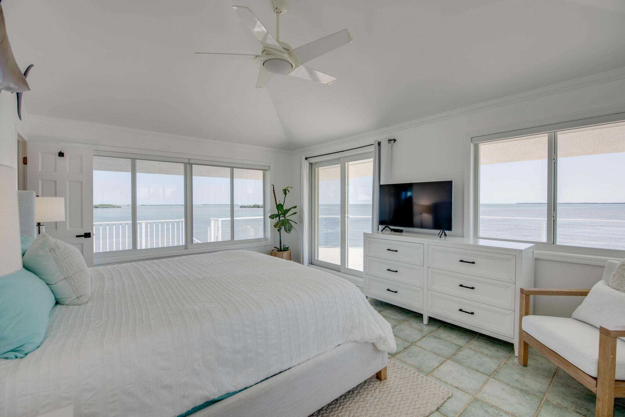 1176 Thatch Lane Cudjoe, FL 33042 - Photo 26 of 41 a large white bedroom with a large bed and a flat screen tv