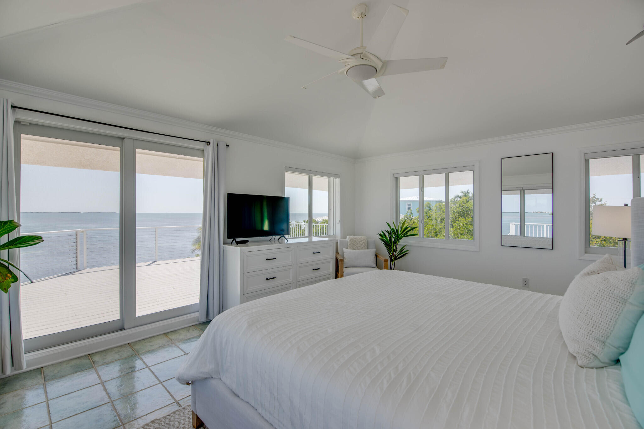 1176 Thatch Lane Cudjoe, FL 33042 - Photo 27 of 41 a bedroom with a large bed and a flat screen tv