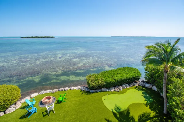 a view of a chair and table on the deck