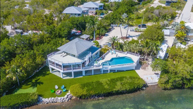 an aerial view of a house with a garden and trees
