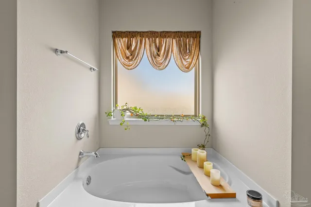a bathroom with a bathtub and a window