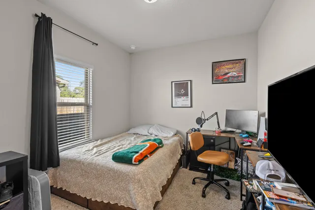 a bedroom with a bed and a flat screen tv