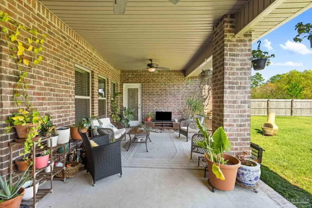 a view of a patio with couches and potted plants